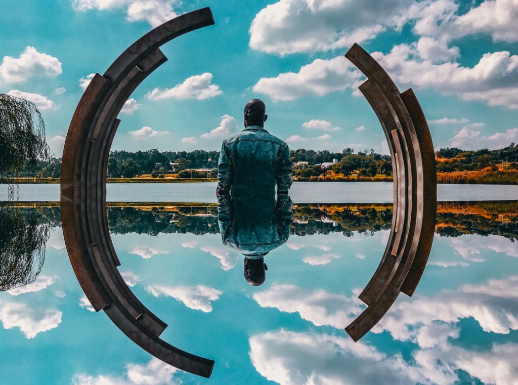 man standing near body of water