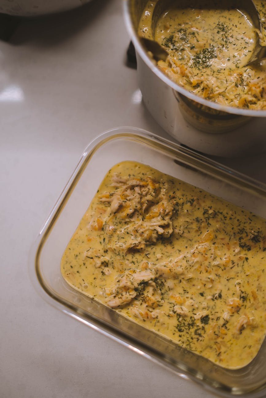 appetizing chicken soup in container placed on table