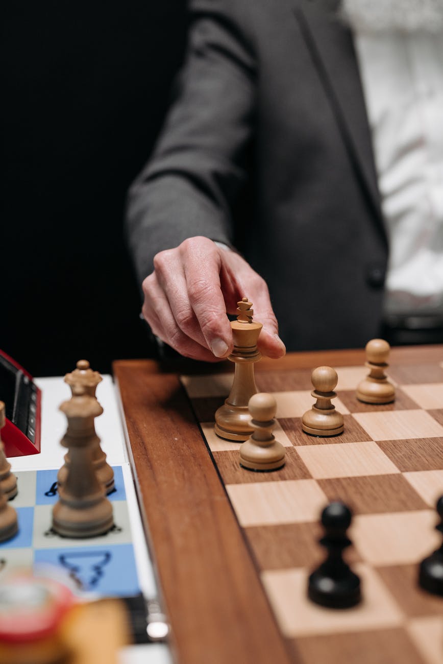 person wearing a coat playing chess