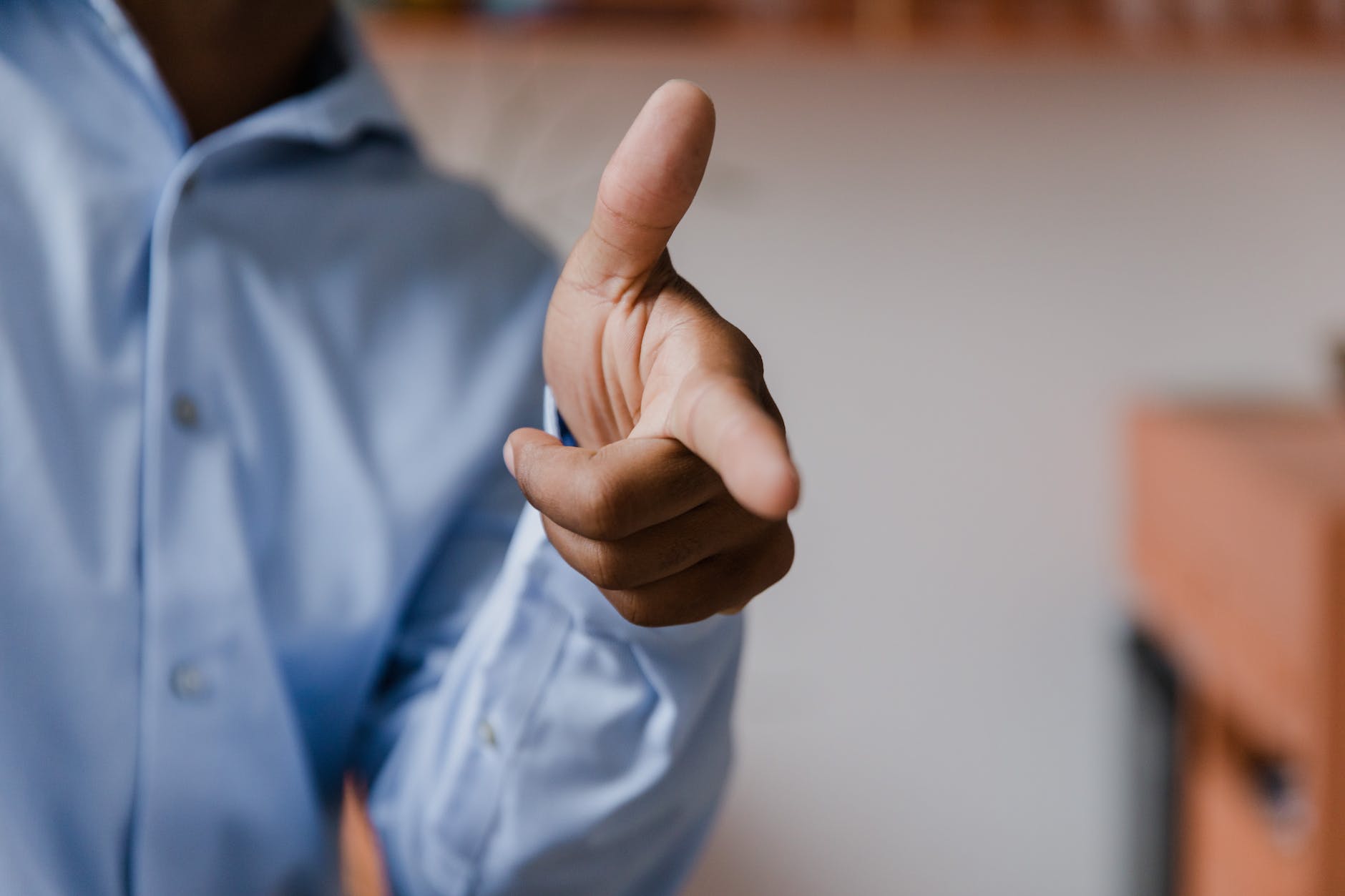 male hand making pointing gesture with stretched forefinger and thumb