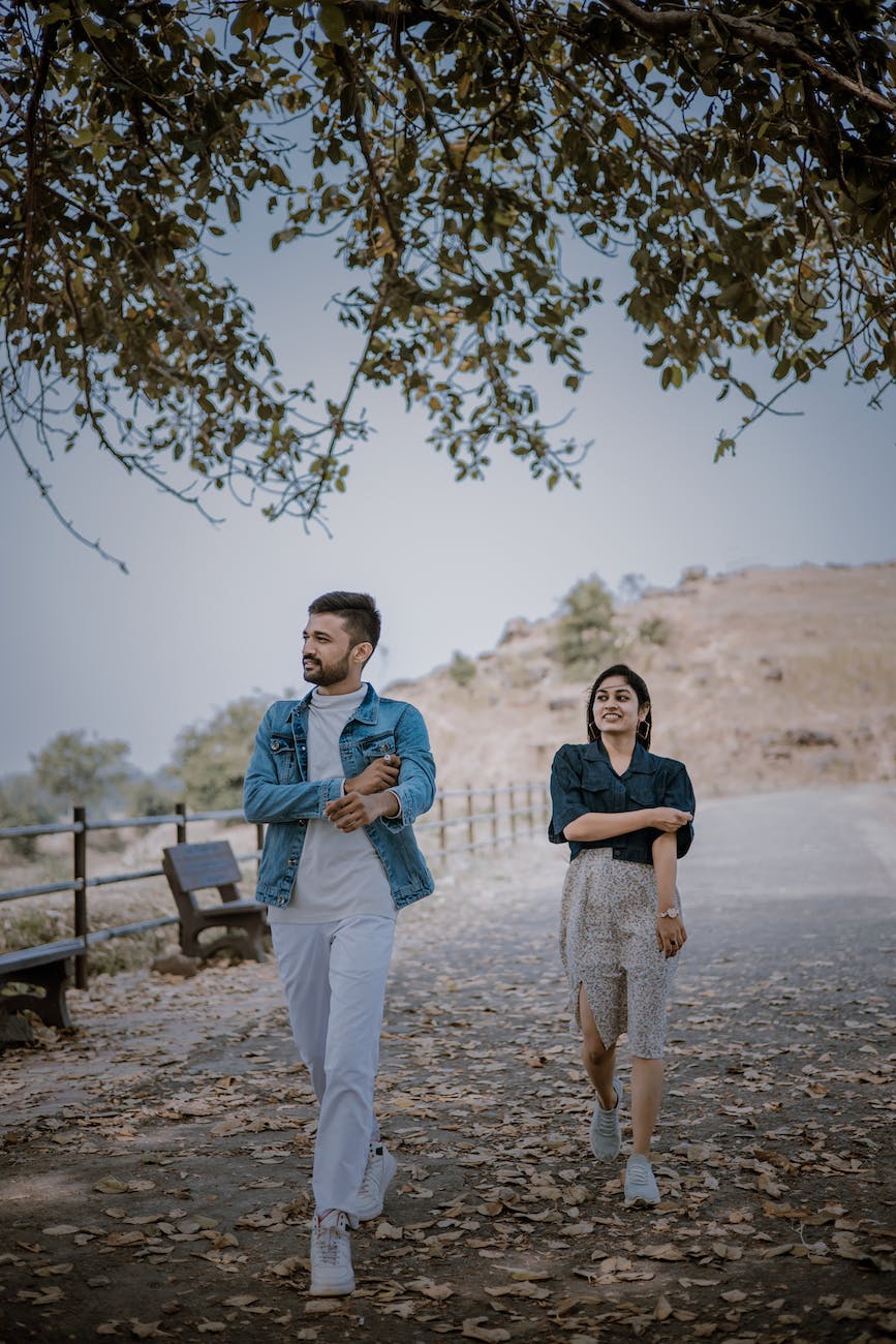 young couple strolling in autumn park