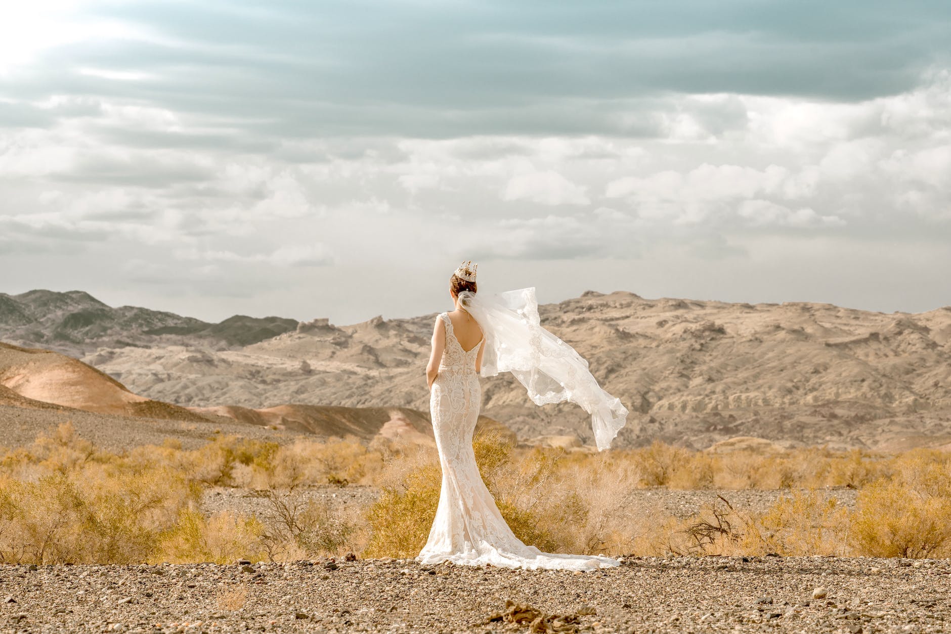 bride in wedding dress standing in wilderness