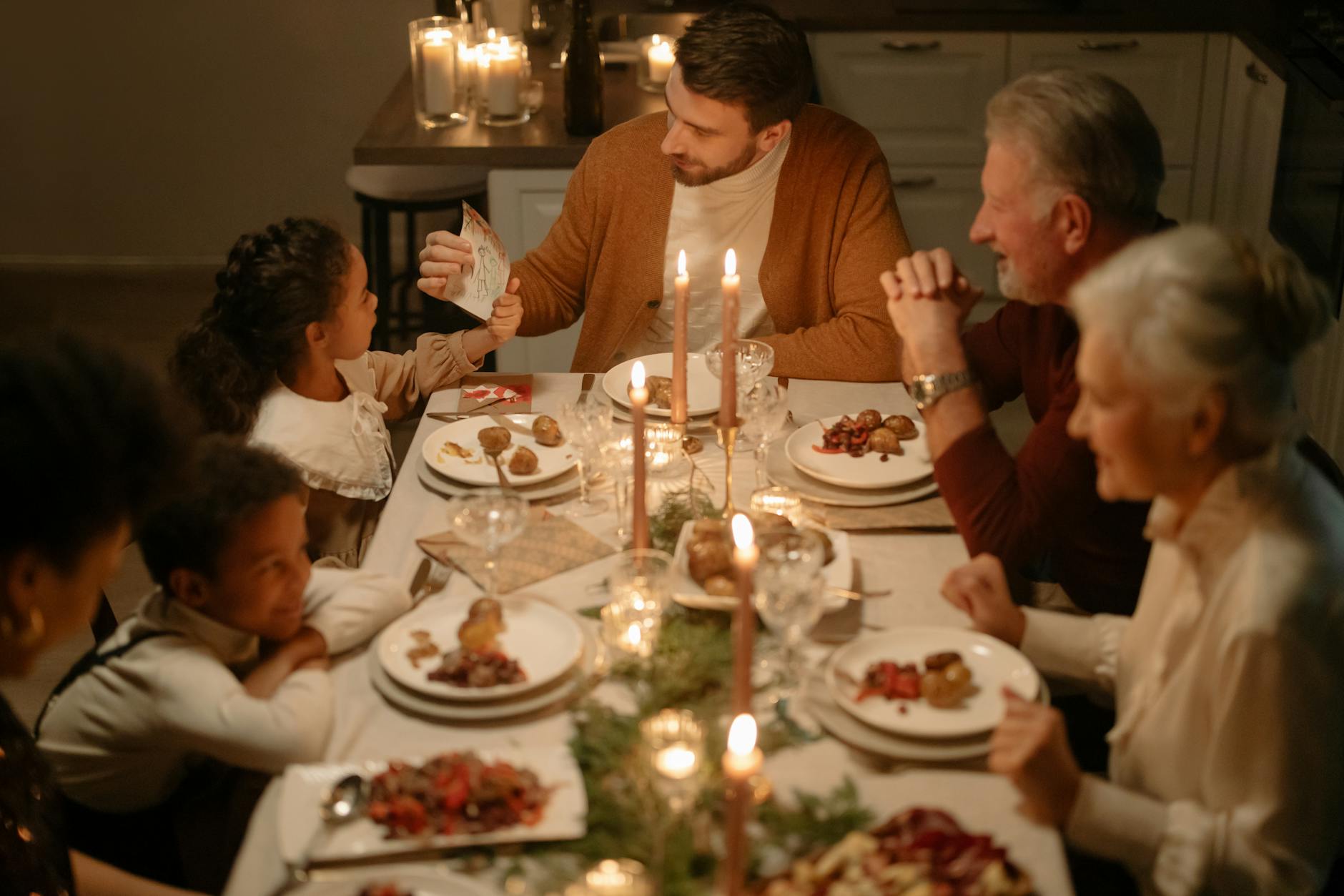 family sitting at the table having dinner